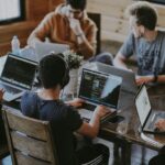 group of people using laptop computer